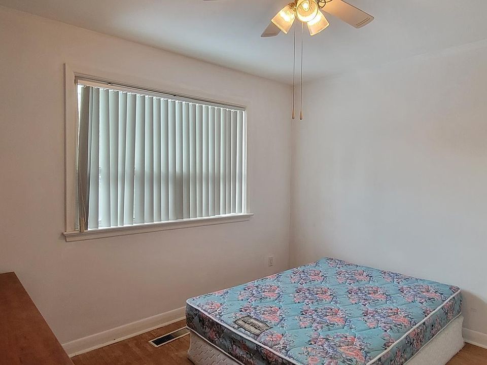 bedroom 2 , hardwood floor, west view to back yard, closet, fan