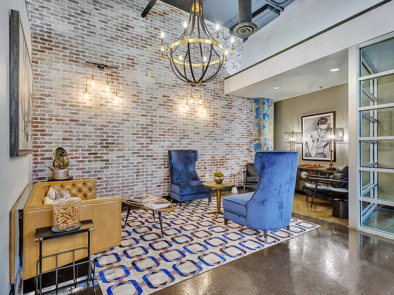 Leasing office, cozy lounge area with beautiful brick wall