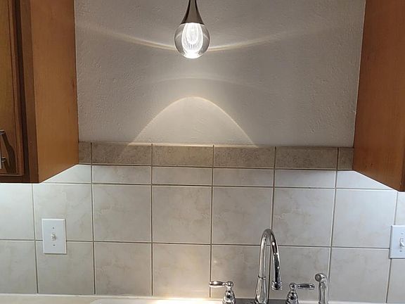 Elegant pendant light over double sink with new garbage disposal