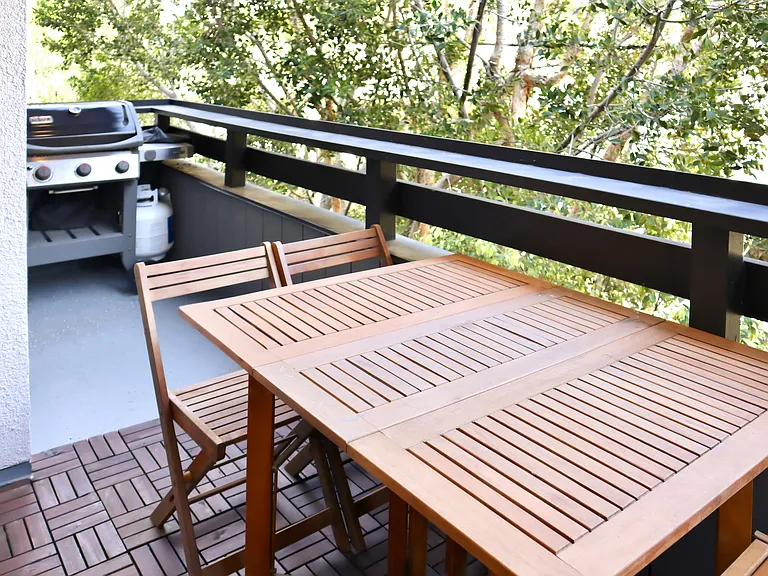Large balcony with seating for 4 and gas barbecue.