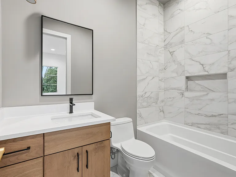 Stylish bathroom with soaking tub and modern accents