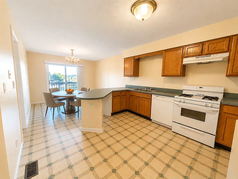 Kitchen with large eat in area - virtually staged