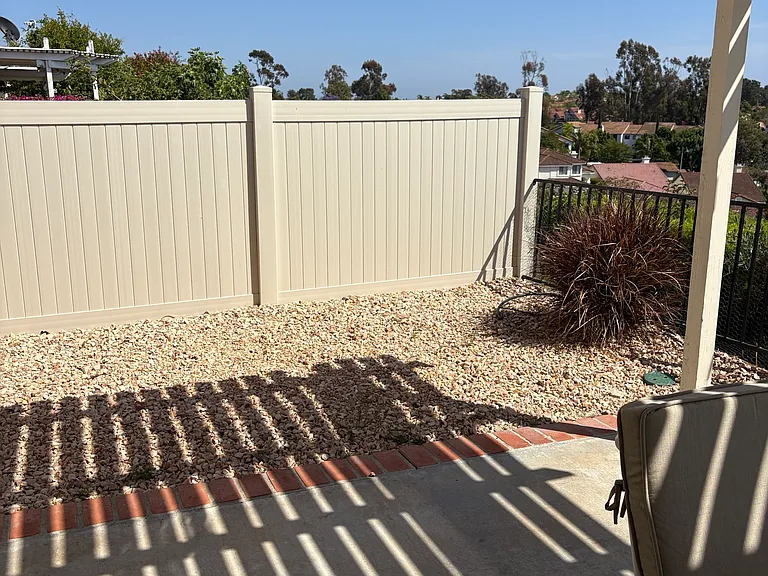 Side yard with vinyl fence.