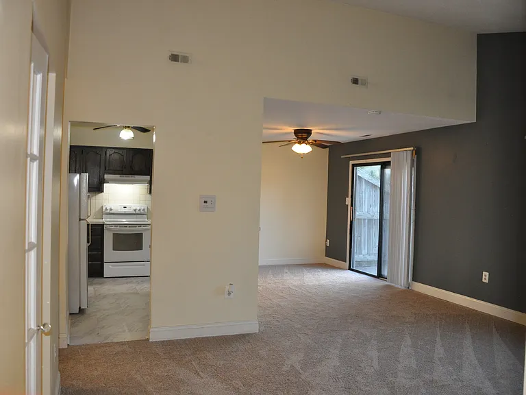 Open floor plan with vaulted ceilings and sliding doors to the back patio