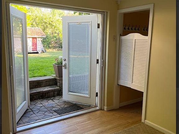 foyer opening onto backyard, laundry room behind swinging doors