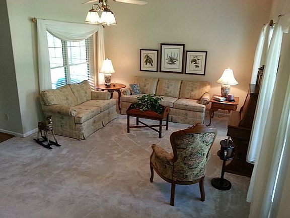 Enter into the large formal living room with several windows that allow tons of light to enter the room.