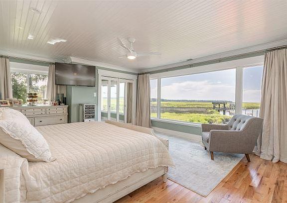 Second large window in Master bedroom with two built-in mirrored customized closets.