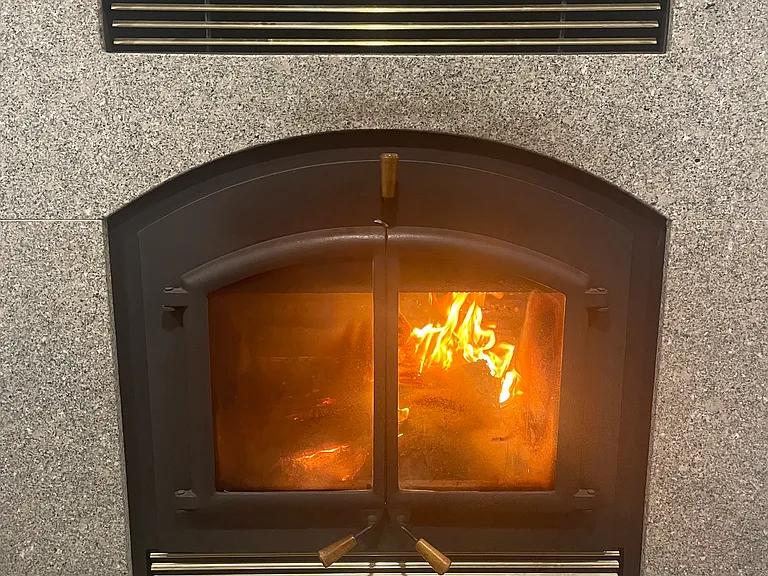 The den has a wonderful wood burning fireplace.