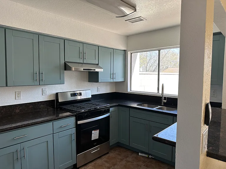 new kitchen with new gas range. hood, faucet.