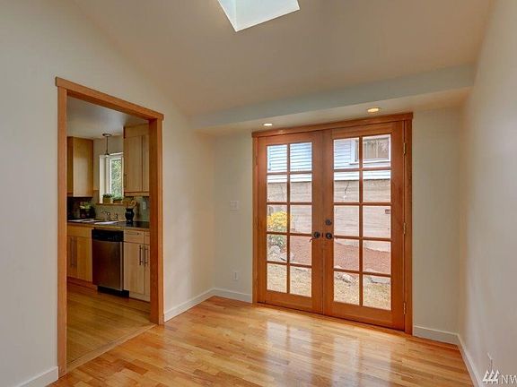 Dining room with French doors to the outside.  Skylight for more light. 