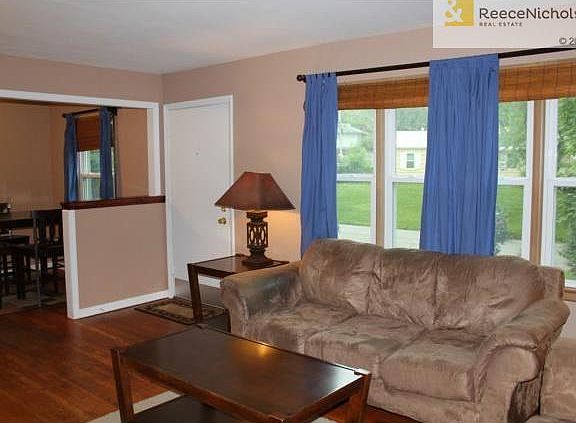 The spacious living room boasts new windows and hardwood floors.