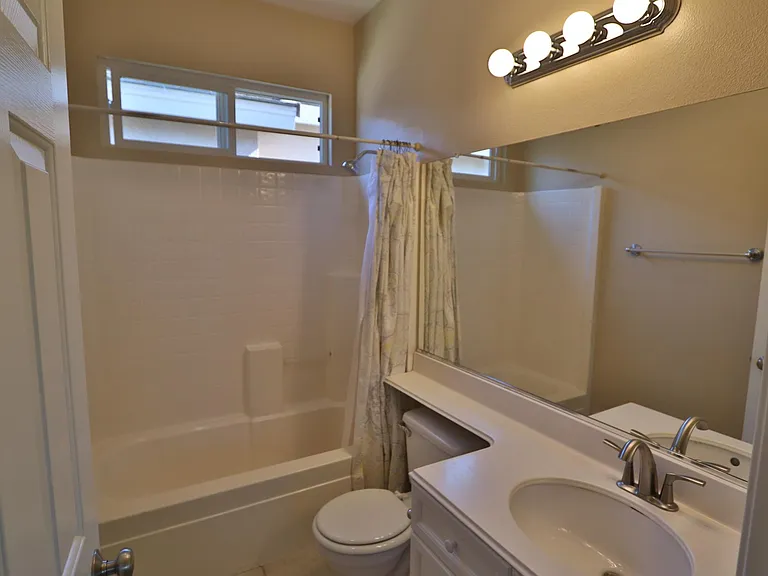 Hall bath with soft white LED lighting and good size window for fresh air.
