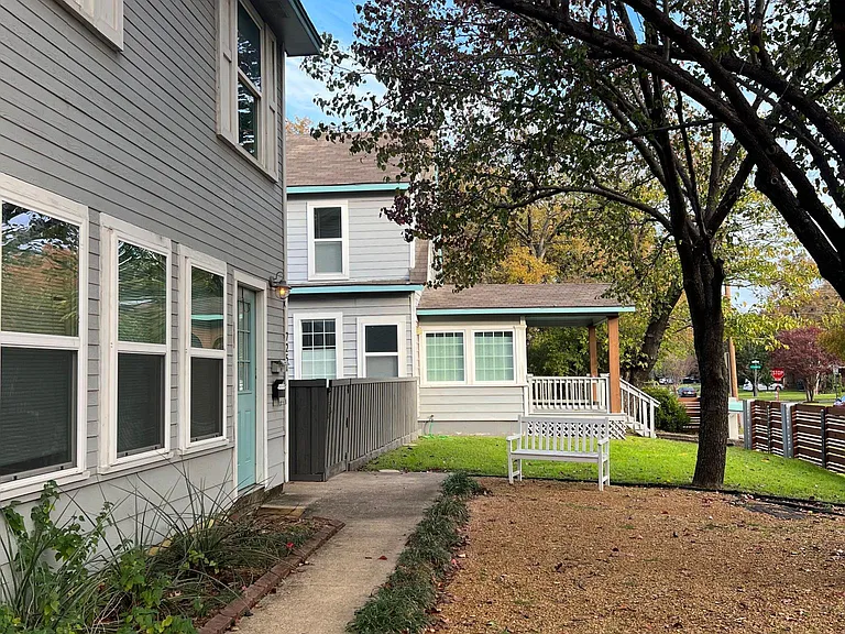 This is the path you'd walk from the large on-property parking lot over to the home. The building on the left are the 2 apartments on the property.