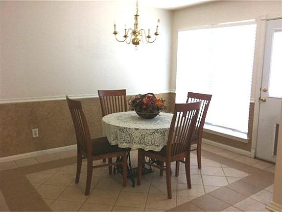 Formal dining with ceramic tile flooring and accent paint