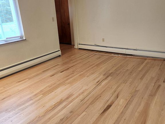 Recently refinished hardwood floors in dining room/living room space