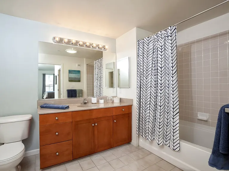 Classic Package I bath with cherry cabinetry, laminate countertops, and tile flooring