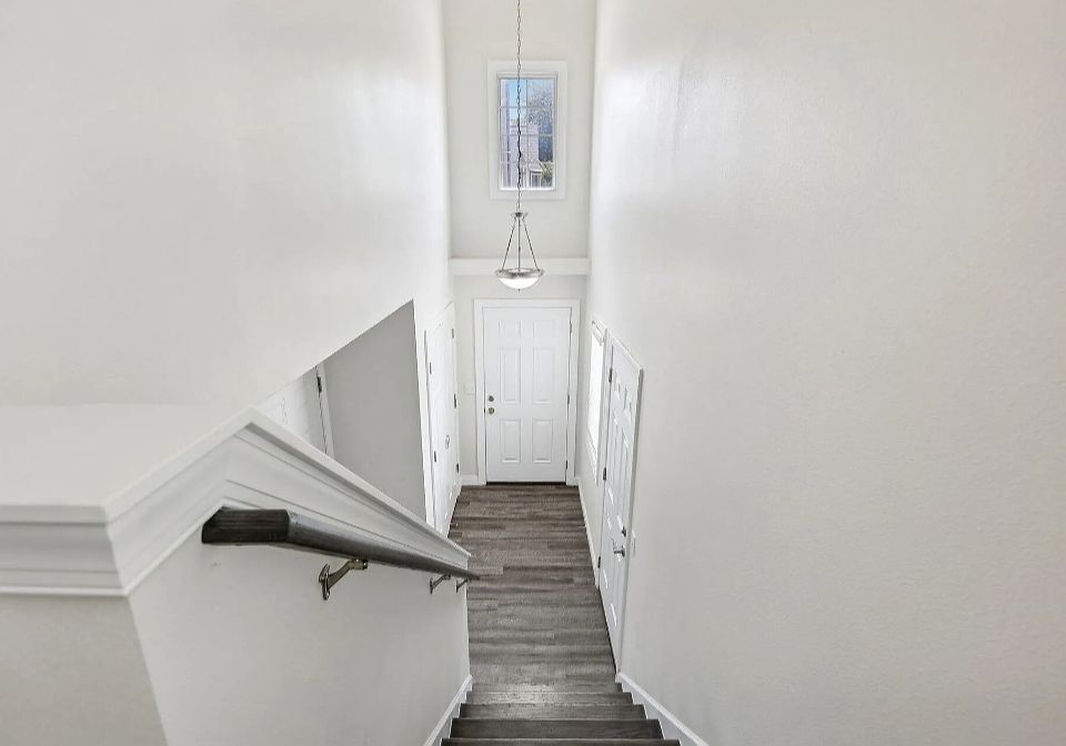 Interior view of front door from living room, kitchen space