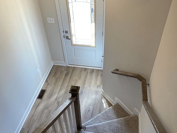 Entry area and carpeted staircase