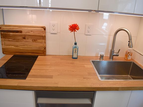 Extra deep sink with disposal, dishwasher, electric cooktop, microwave & refrigerator.