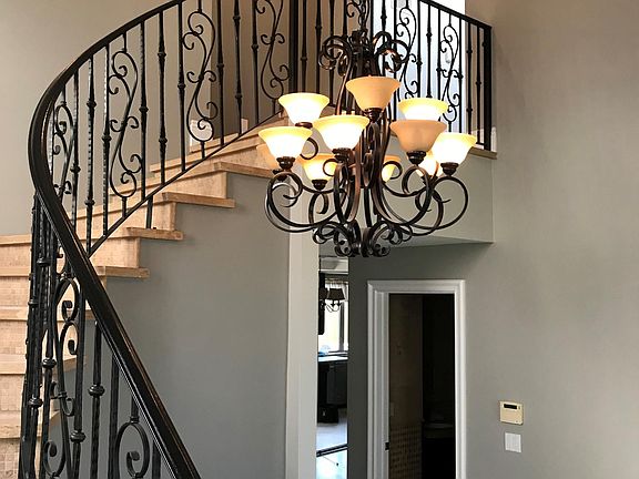 Beautiful entry-way with spiraling stairs.