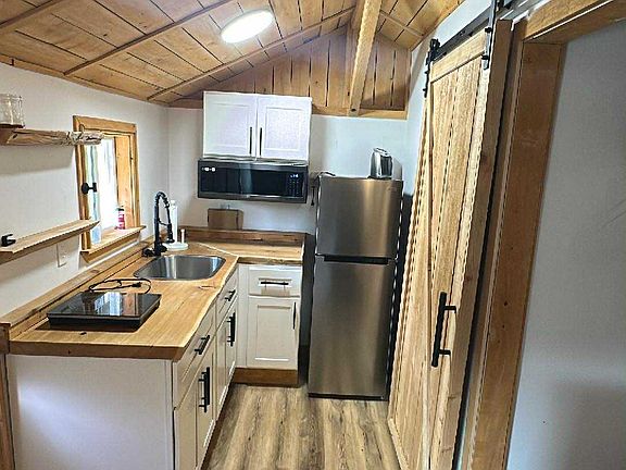 Kitchen has convection / air fryer microwave, Freezer and fridge, and Induction stove top