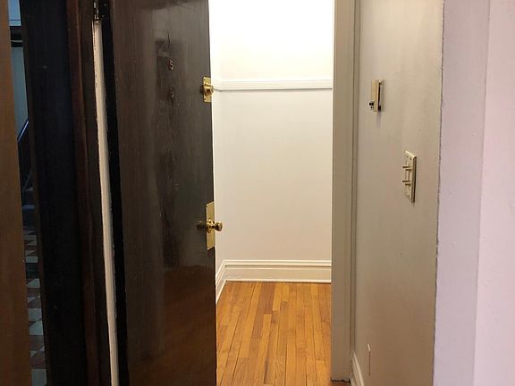 Hallway to bathroom and exit to main hallway on the left