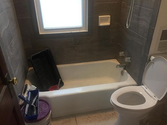 New porcelain tub surround and floor