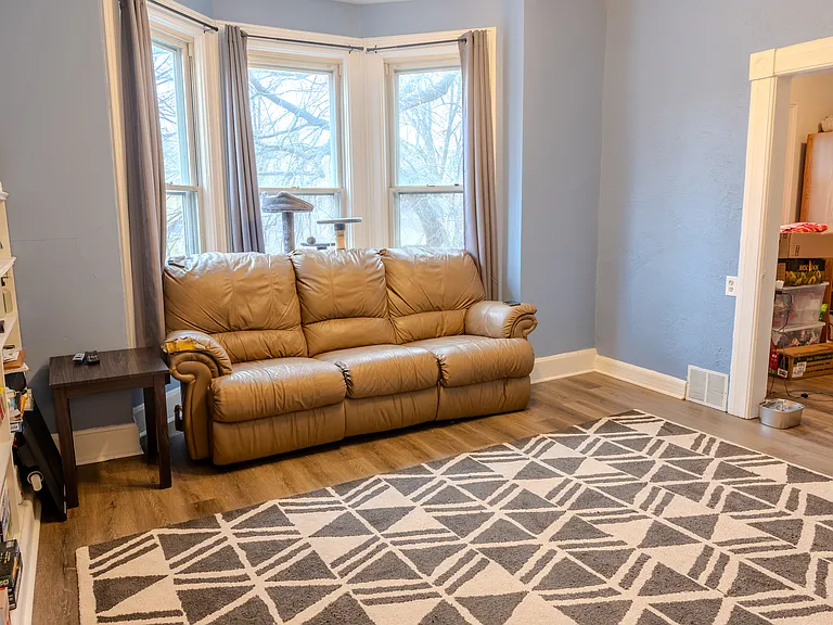 Living room with an attached den/office, perfect for work or relaxation.