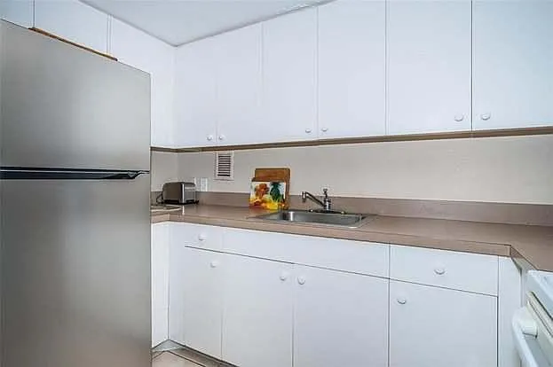 Kitchen with newer refrigerator. No water or ice but ice machine in building on first floor.