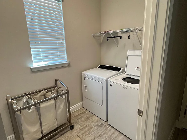 Laundry room with utility sink and built-in cabinets