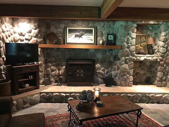 Cozy gas fireplace and heated floors in living room.