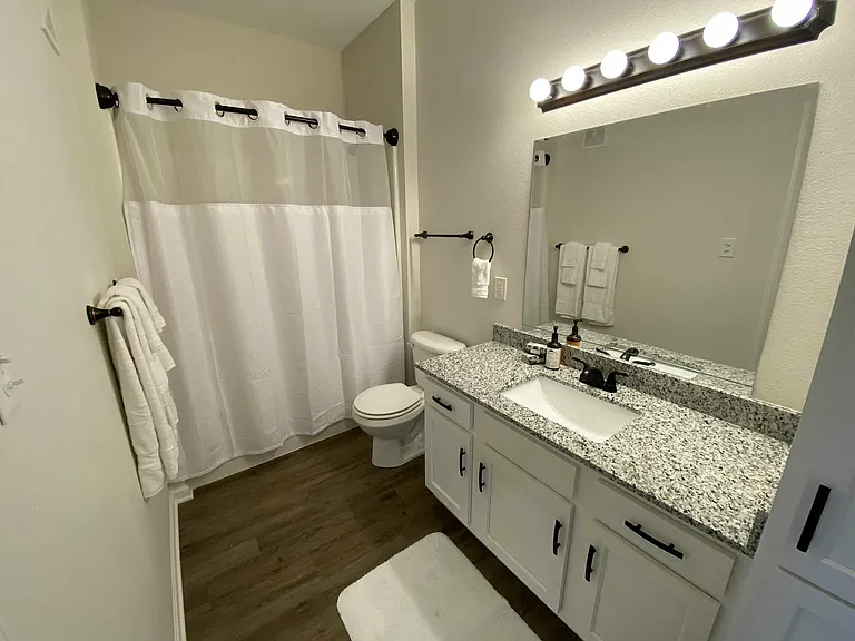 Whether it's a quick rinse or a long soak, this bathroom delivers, complete with built-in cabinetry and a spacious vanity that keeps the clutter away.