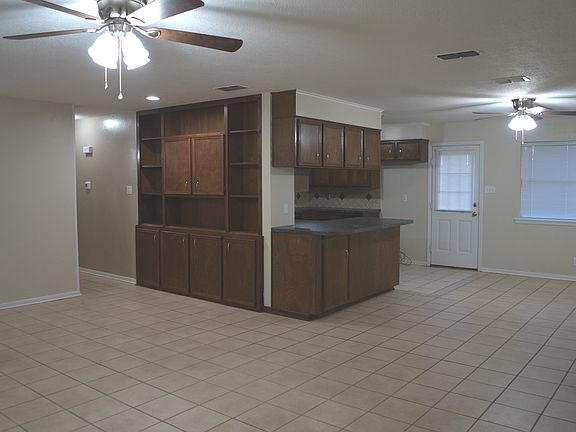 View from the living room of the dining area, kitchen and hall to bedroom