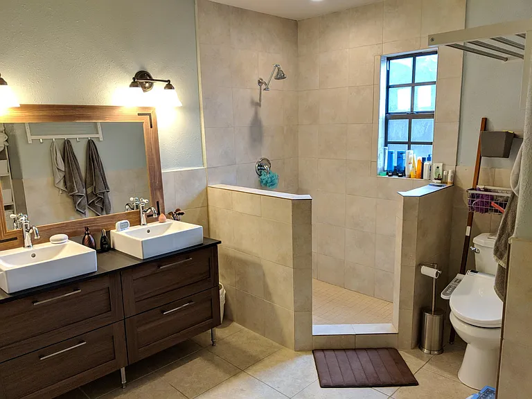 Bath with with new vanity before glass shower enclosure