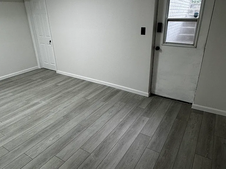 Entry Door. Bedroom 1 is to the left. When you walk in, you come into a flex space, facing the kitchen