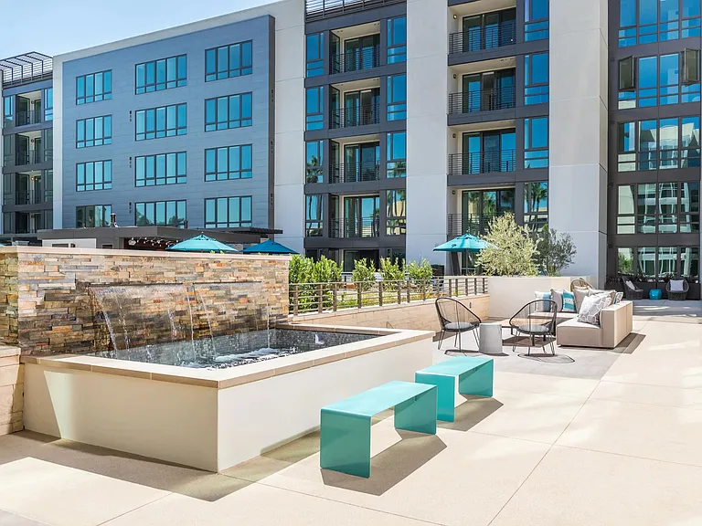 Outdoor lounge with bar seating and fire feature for evening gatherings.