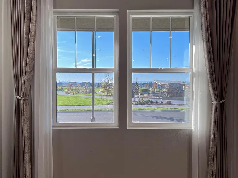 living room windows are facing community park with sunlight