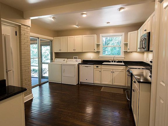 Kitchen entry. White washer and dryer have been replaced with new stainless units.