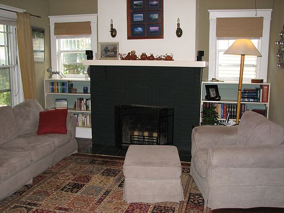Living Room with Hardwood Floors, Fireplace & Built in Bookshelves