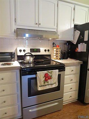 This kitchen has a tremendous amount of cabinets, center island, and dining area