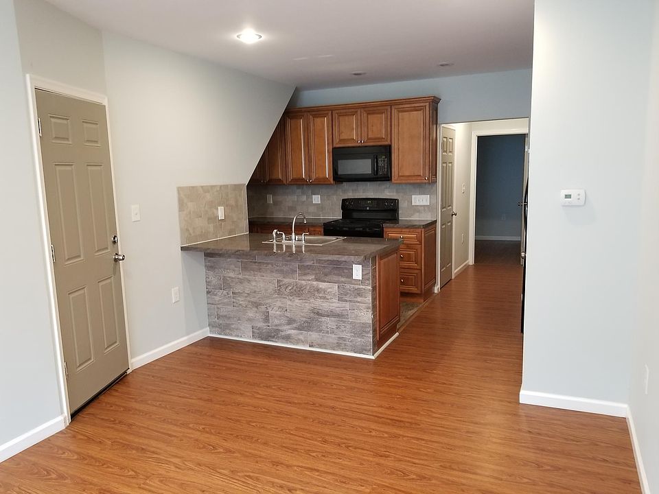 Open Kitchen and living room. Kitchen has tiled floor
