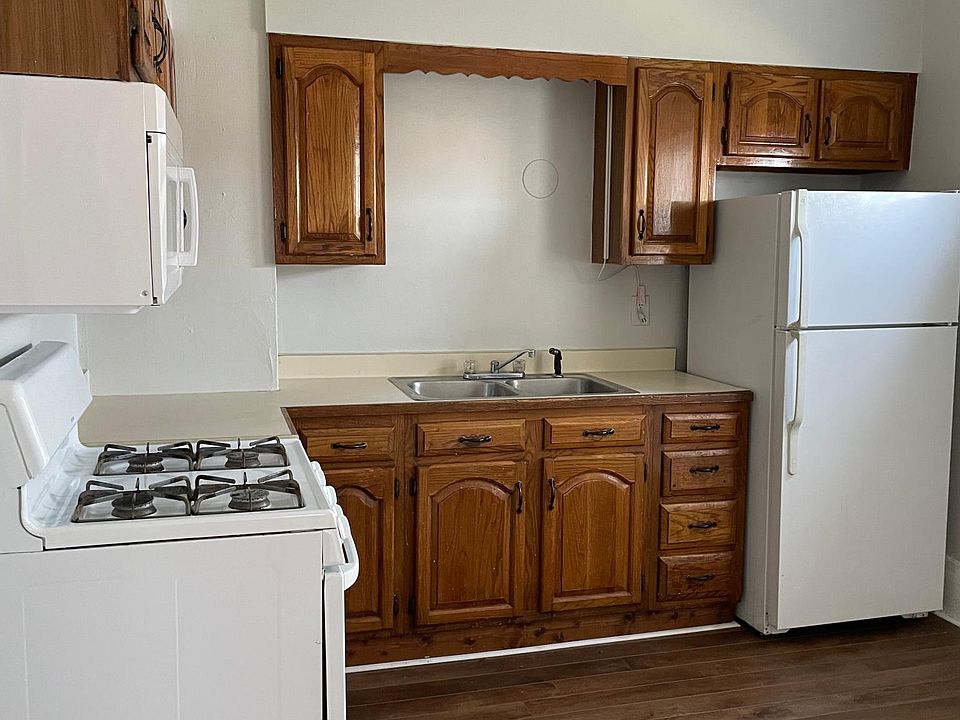 Kitchen with gas stove and overhead microwave