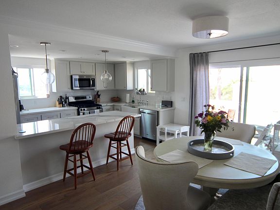 Dining room and kitchen with large, sliding, dual-pane glass door to the balcony