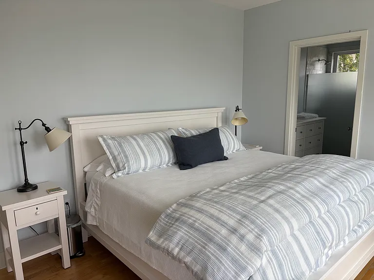 Master leading to ensuite bathroom and overlooking Casco Bay with French doors leading to porch.