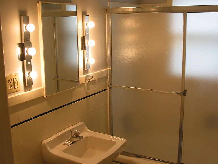 Bath, shower with sliding glass doors.