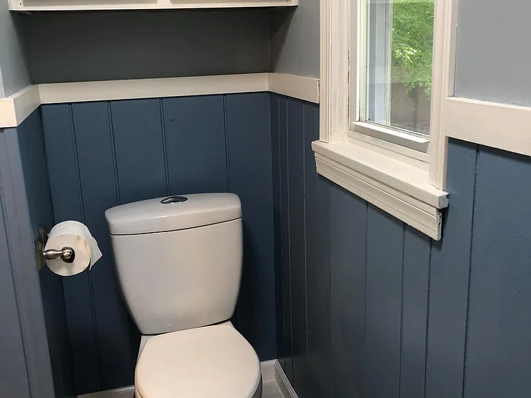 Master bathroom across from tub with towel or toiletry storage.