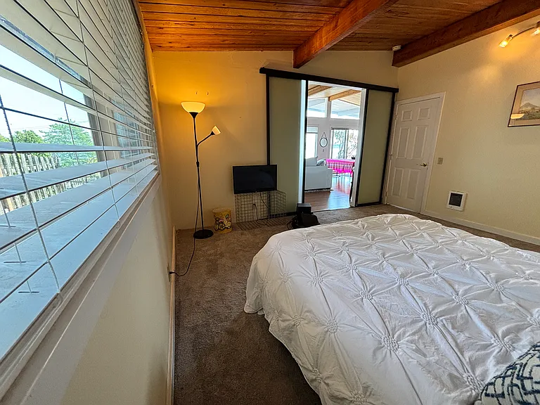 Main bedroom with 35-inch TV, blinds