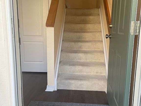 The entryway with an ample-sized coat closet on the left and stairs to the second floor.