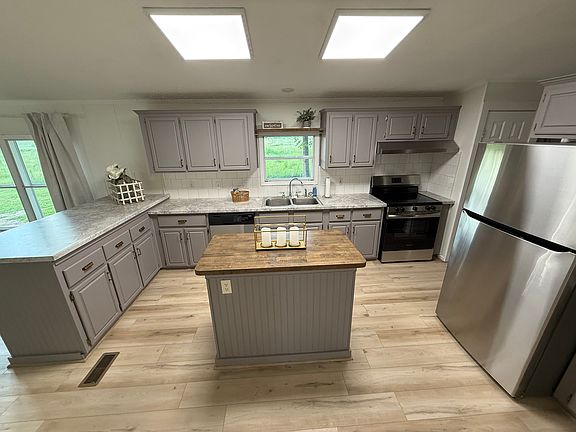 Kitchen with butcher block island, new countertops, and appliances