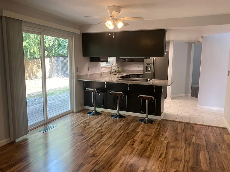 Family Room looking into Kitchen w/ slider to back yard.